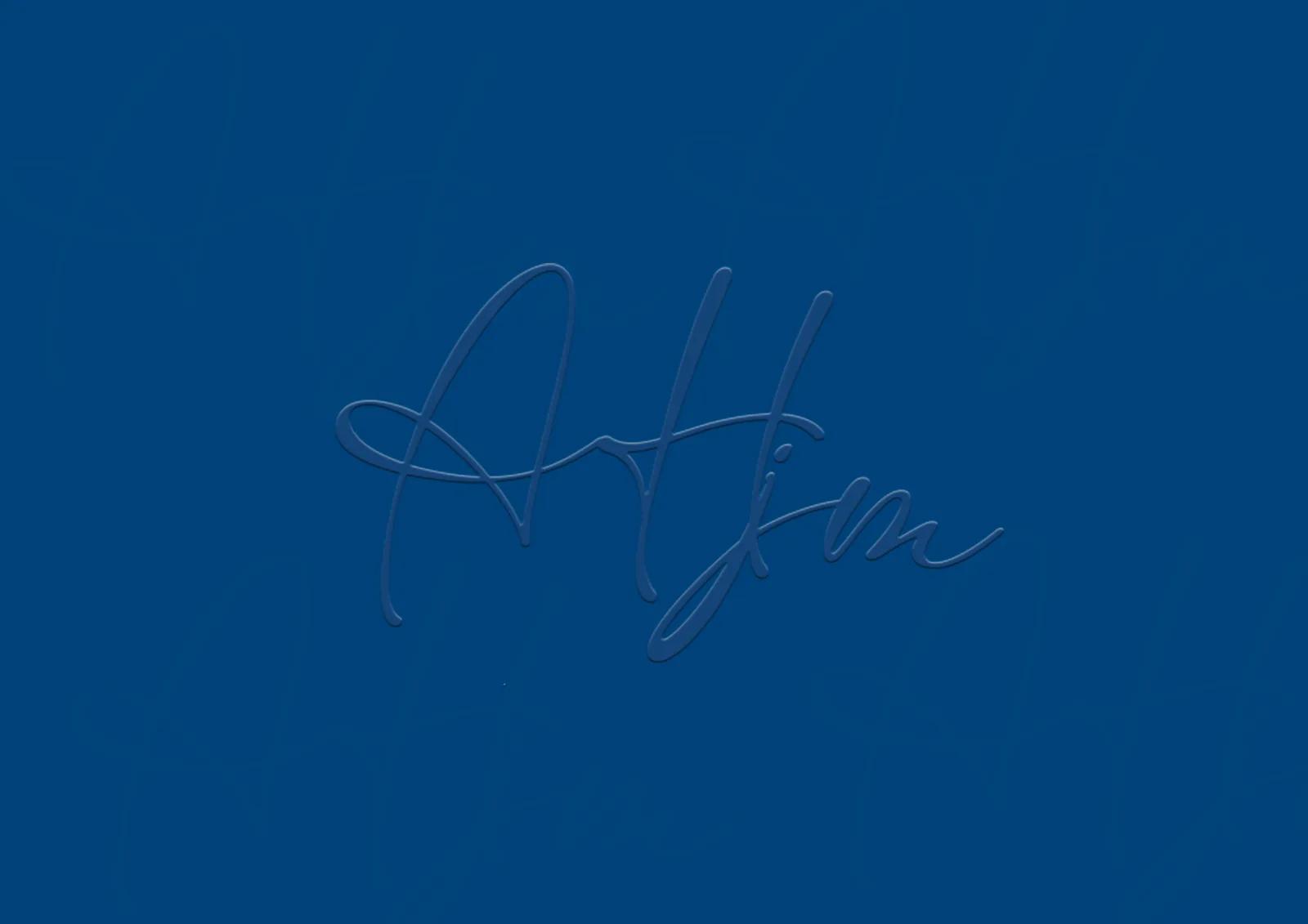 Front of the business card: navy ground, AHJM initials embossed in the centre.