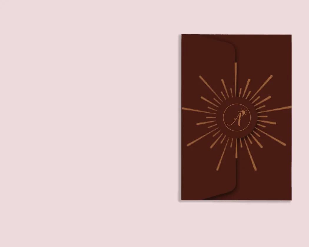 The closed brown holder, with a sun motif around an A monogram.